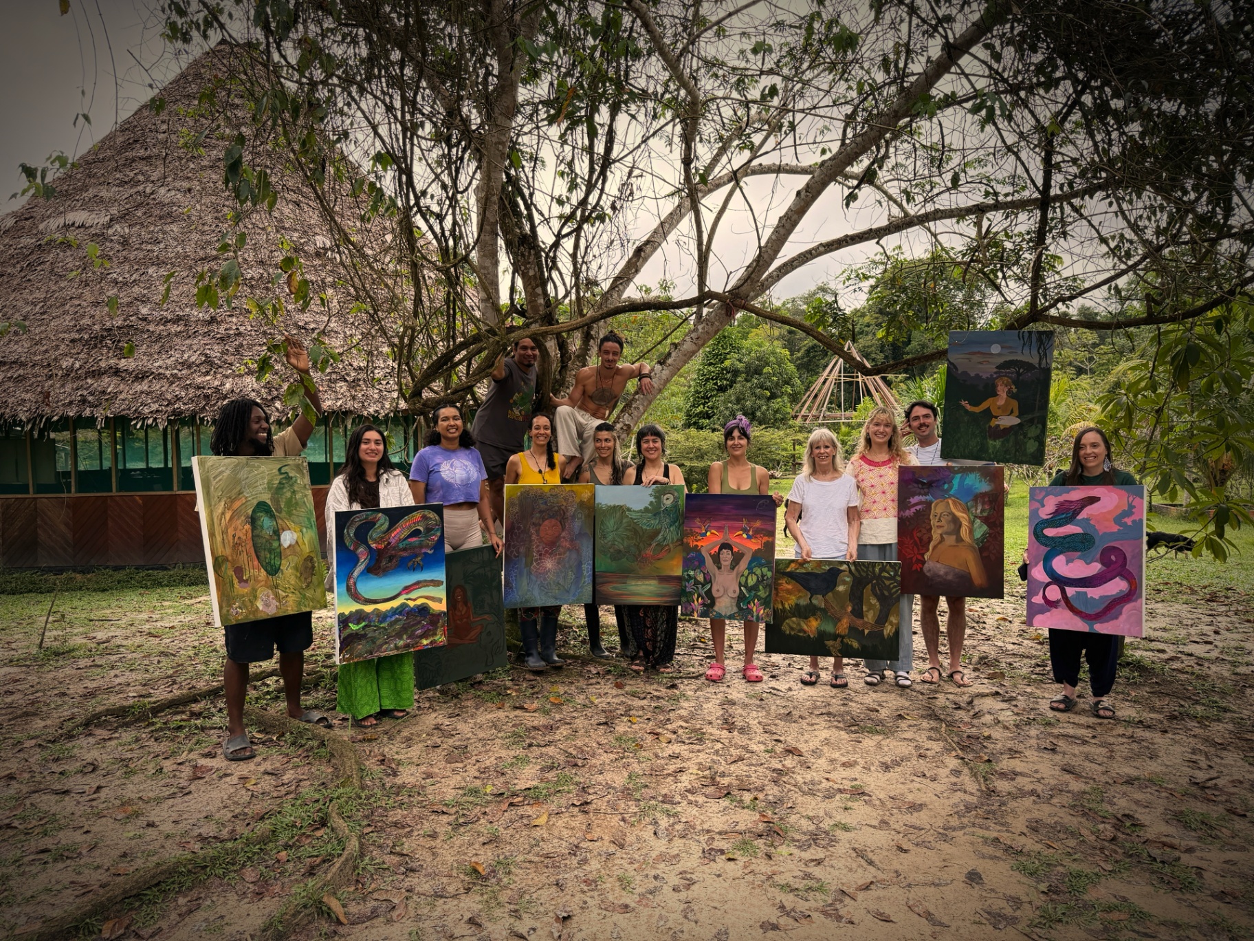 Artists presenting completed paintings in the jungle residency