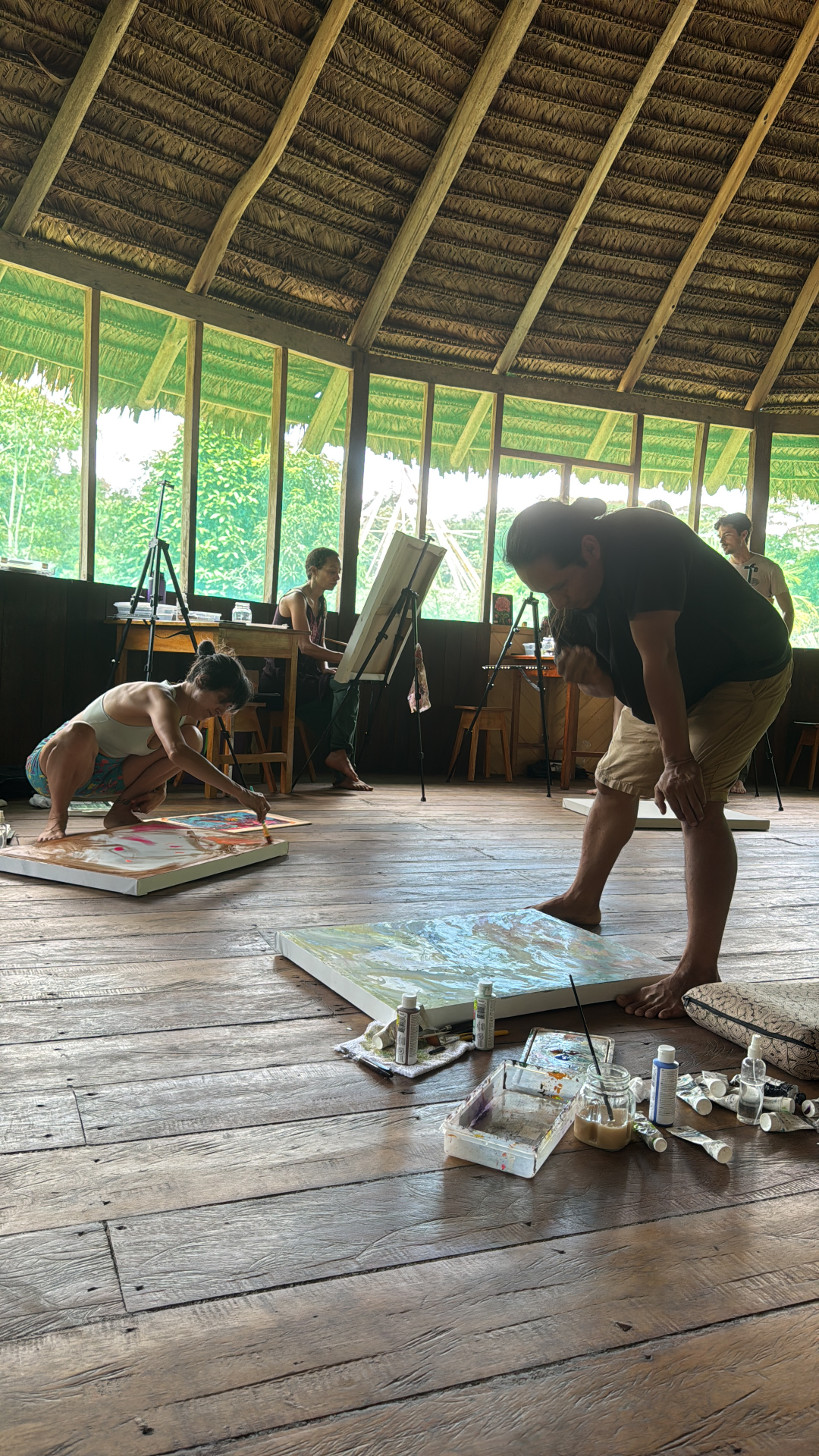 Large-scale painting session on the studio floor